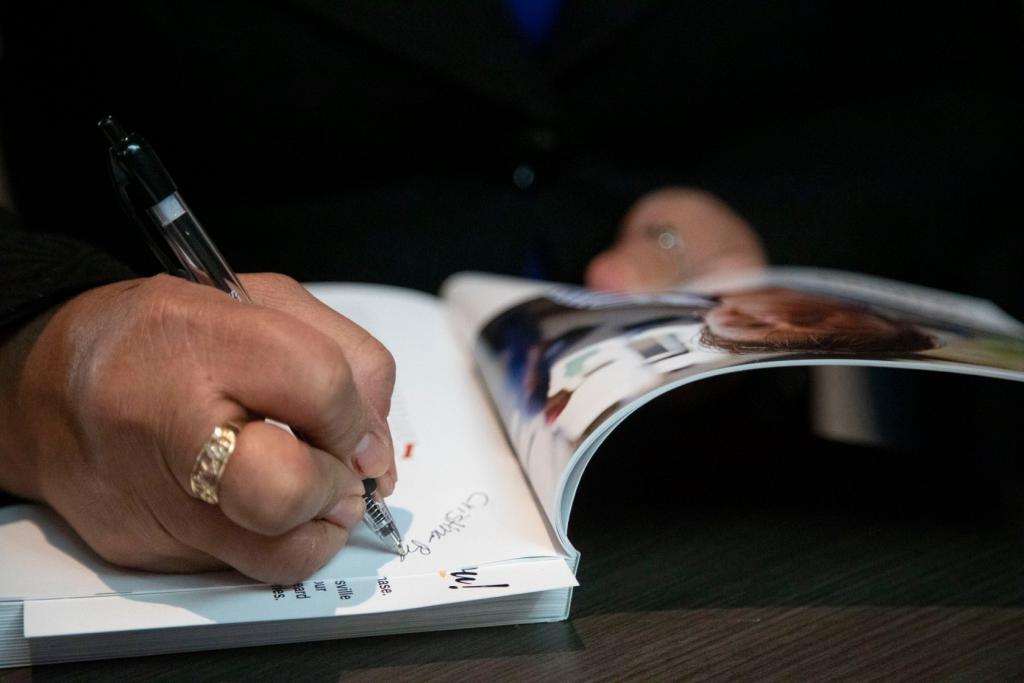 Cristina Bahena signing a book for a fan. (Kertis Creative photo)